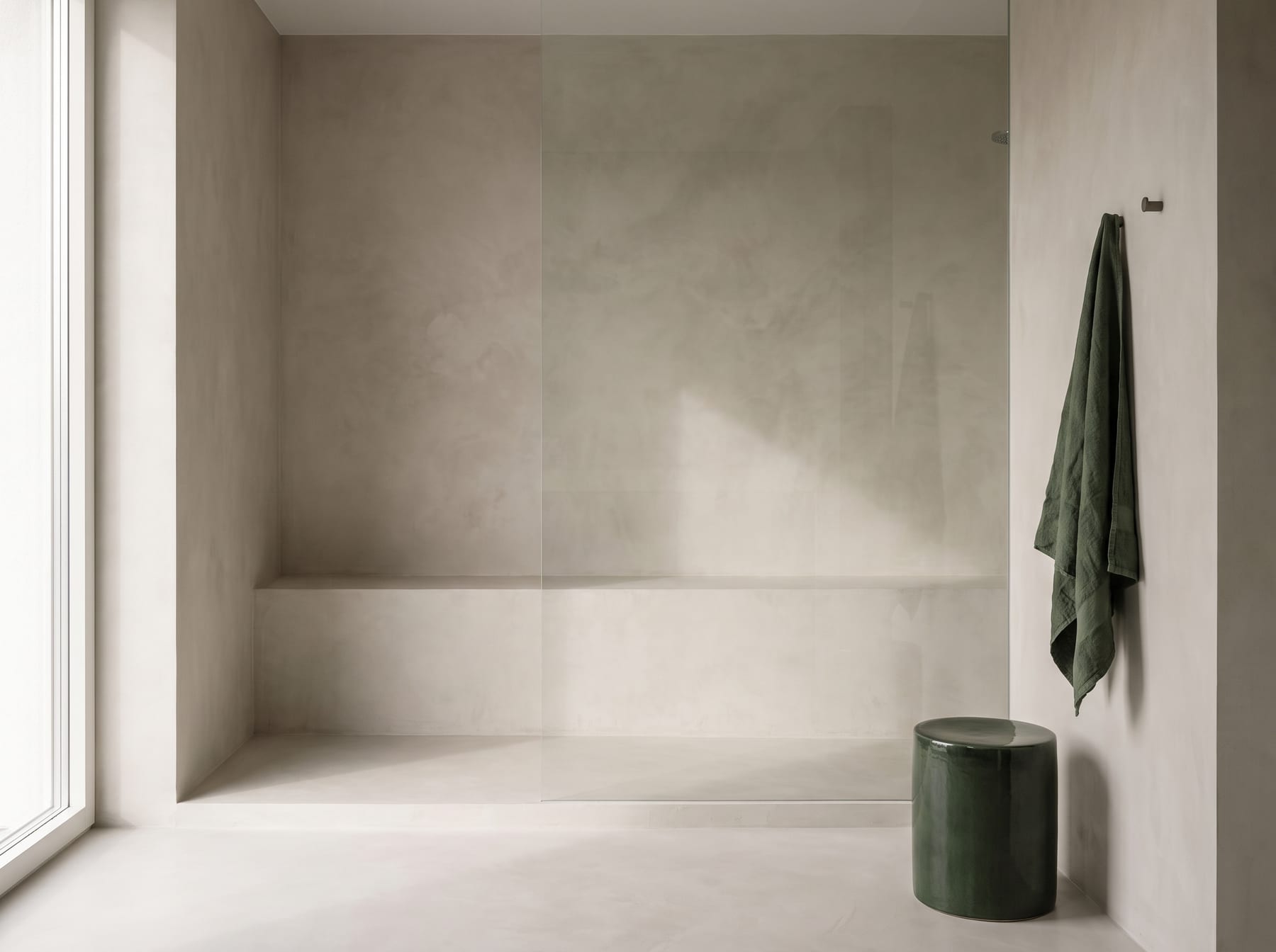 Grout-free microcement walk-in shower in a Dubai bathroom