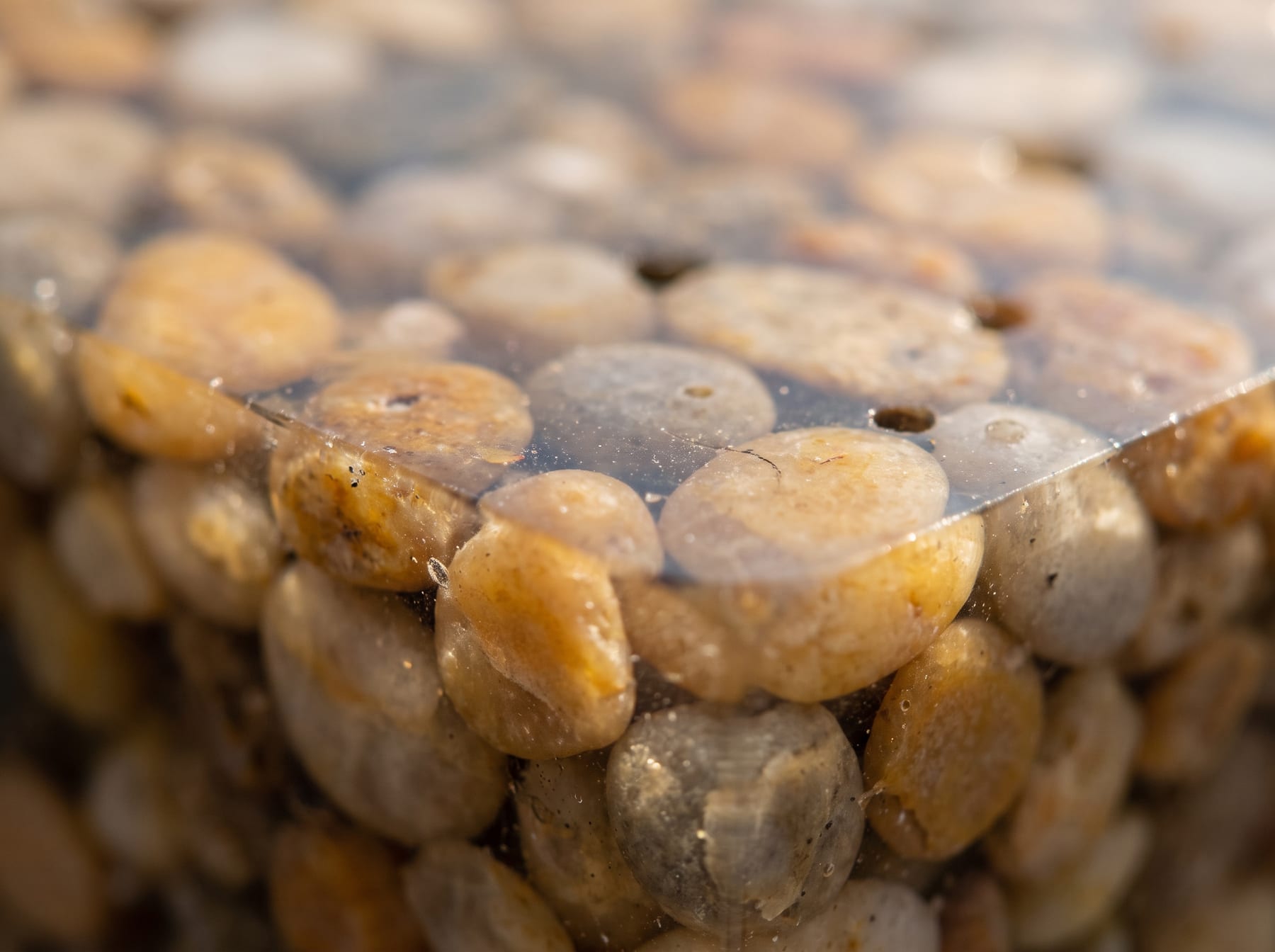 Close-up of a resin bound surface showing natural stone aggregate in clear resin