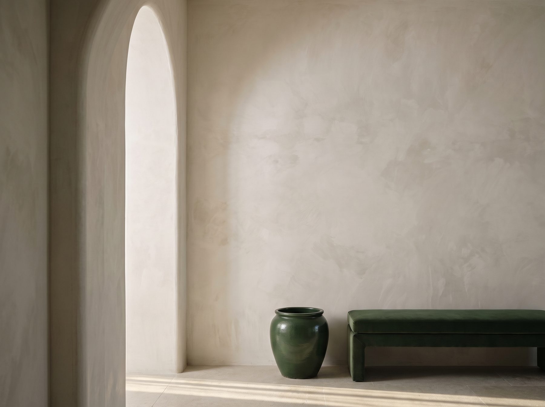 Limewashed interior wall in a soft earthy tone under natural light, UAE